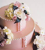 Pink fondant wedding cake with pearls.