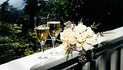 Wedding toasting flutes and cream rose bouquet.