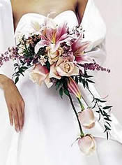 Bride with pink lily and rose cascade bouquet.